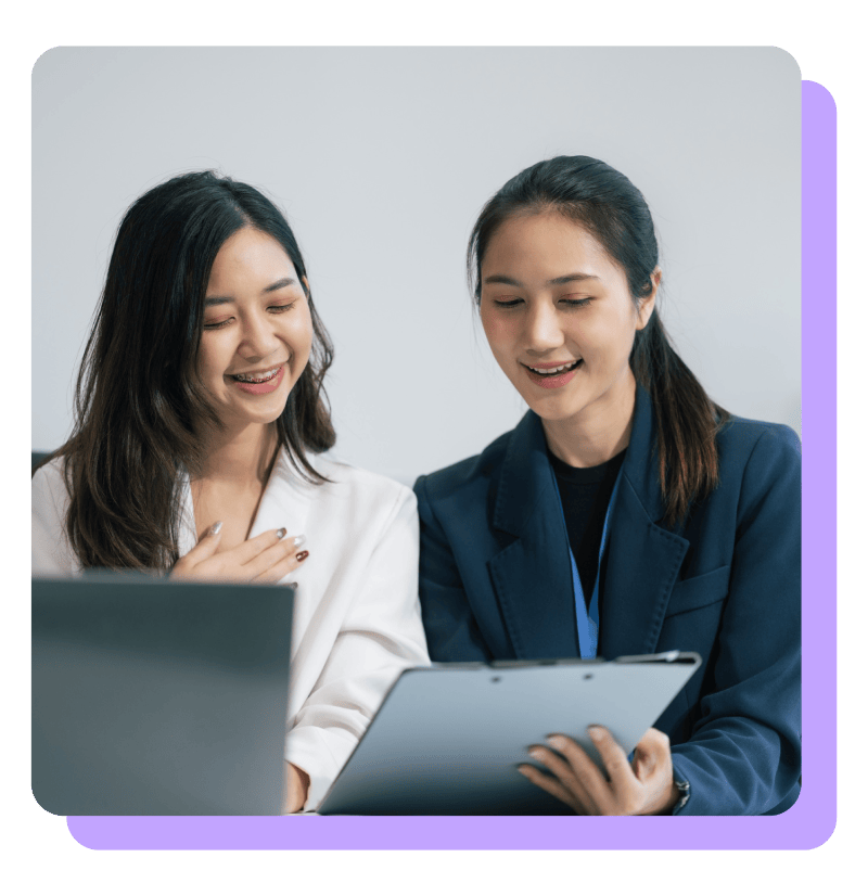 WOman professional helping co worker on computer WOman professional helping co worker on computer