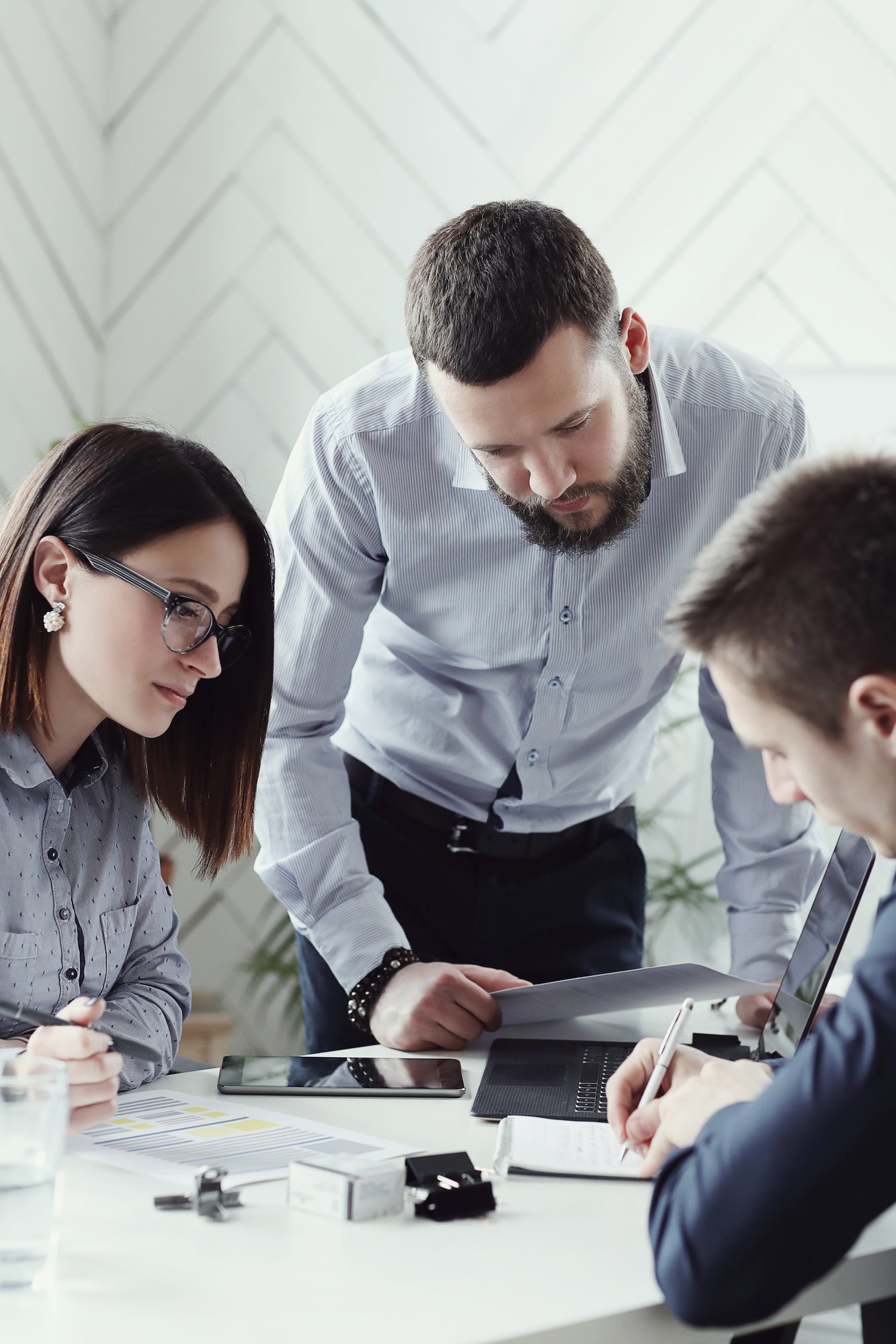 Business people looking at documents on table