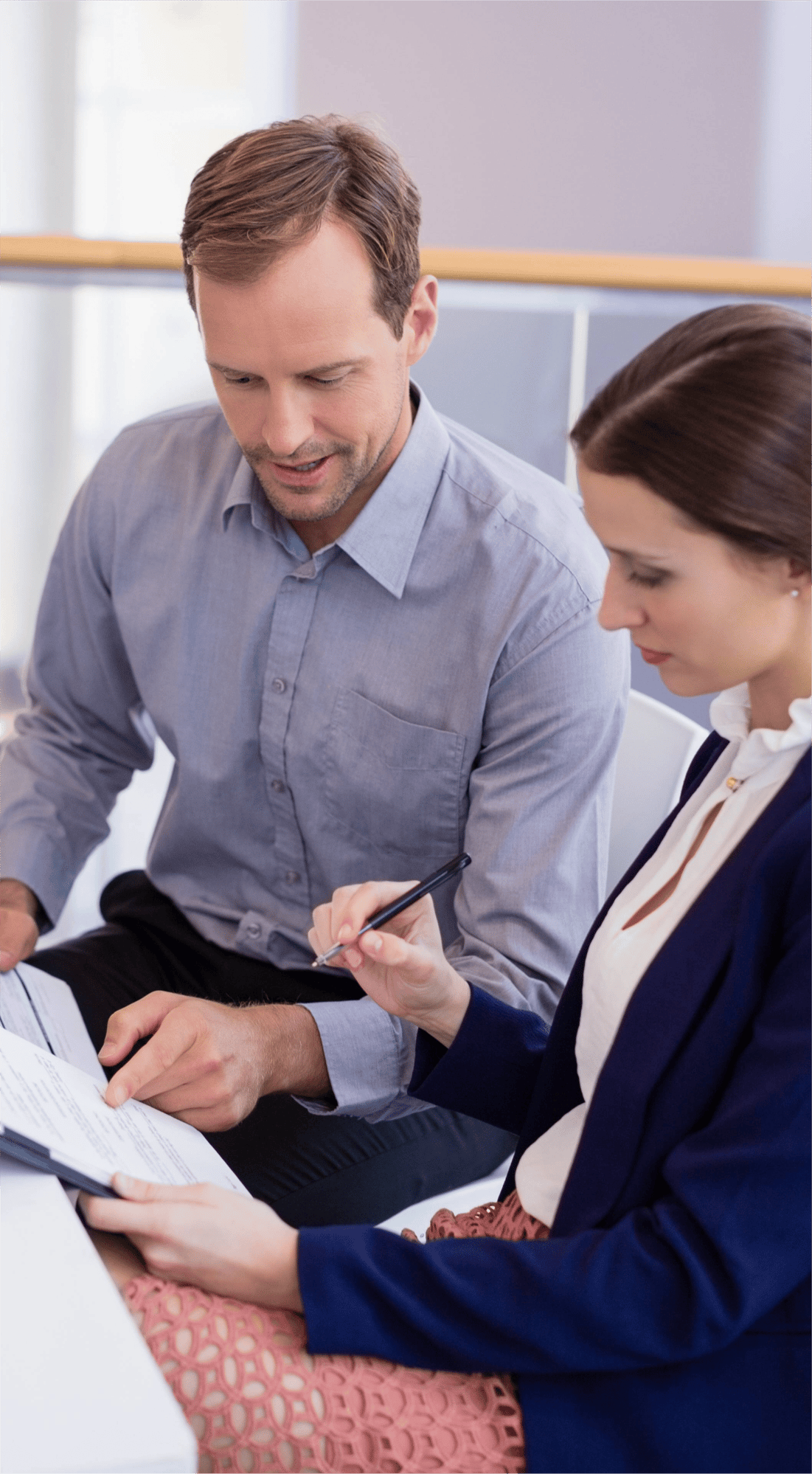 businesswoman-working-at-desk-with-colleague-2023-11-27-05-31-59-utc 1