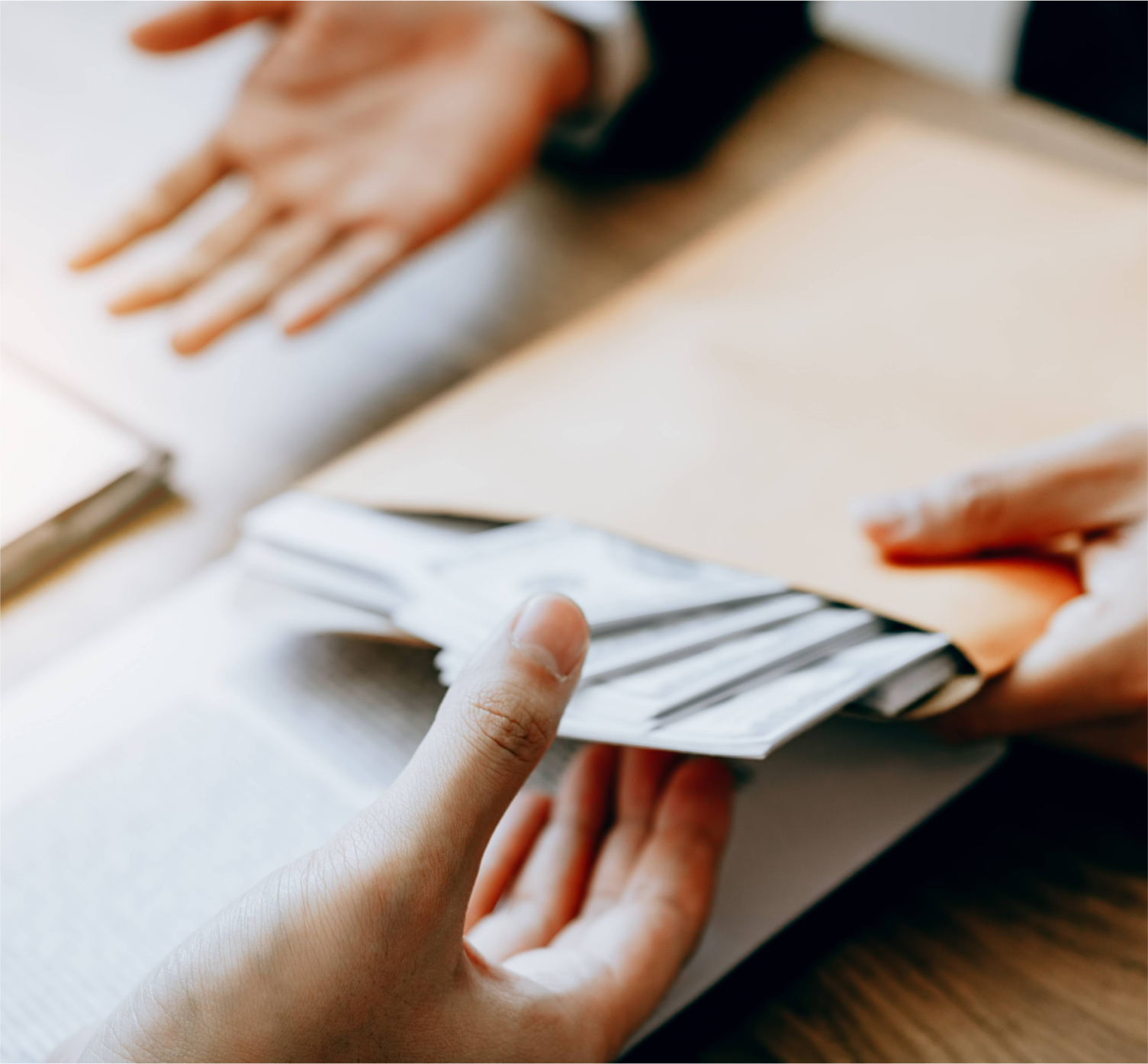 business professional handing money over to a client