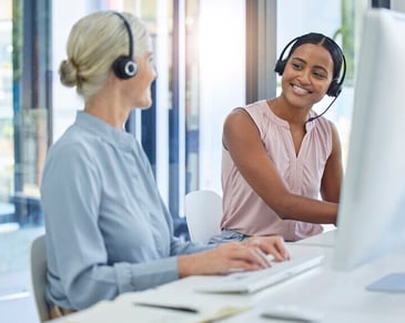two female employees with their headset on