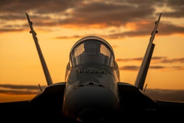 fighter jet with the sunset in the background 