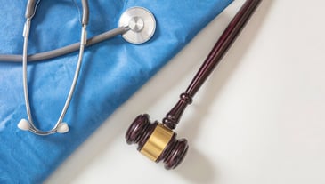 A stethoscope wrapped around a gavel
