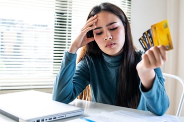 woman stressed with credit card debt
